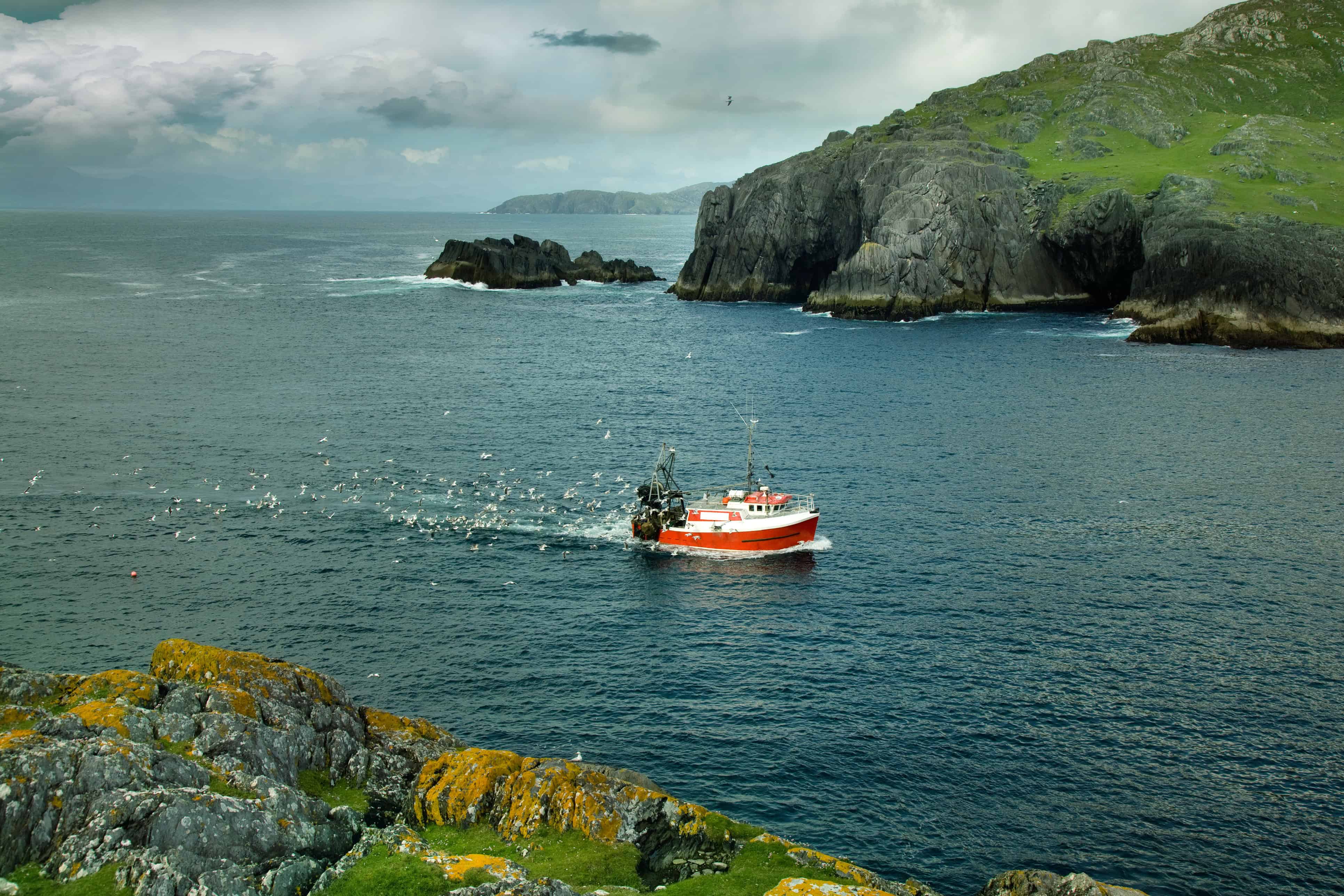 fishing boat returning home before sea storm. Southwest Ireland. Note to inspector: photo is stitched.