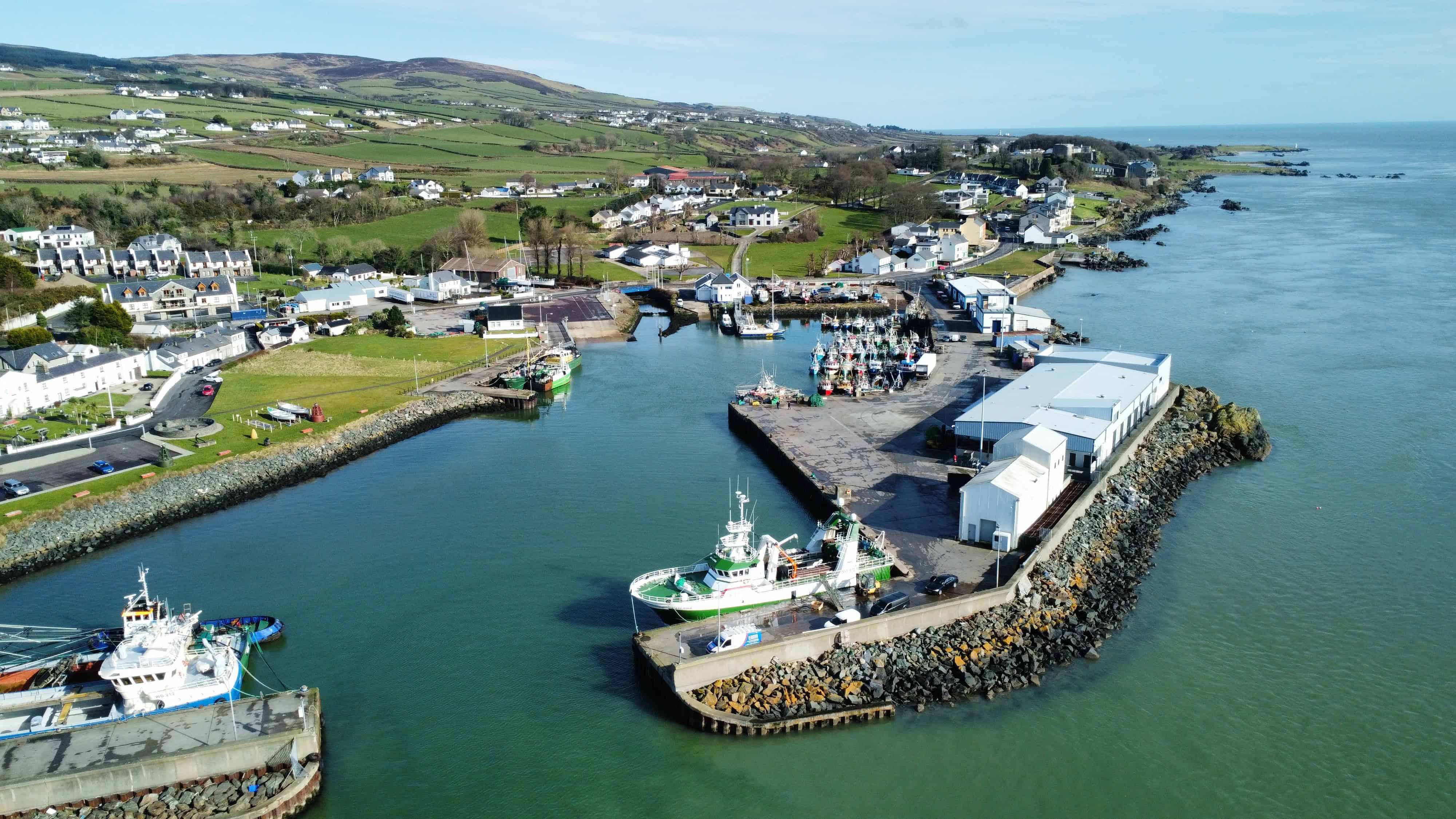 The bird's eye view of Greencastle Harbor with moored boats. Donegal, Ireland.